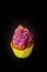 Halloween cupcake with whipped cream purple on a black background