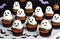 Halloween cupcakes decorated with ghost and bat shape on white table