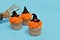 Halloween cupcakes. Witch hat cupcake. Halloween treats on wooden blue background with palm of the skeleton.