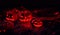 Halloween, cyber party, neon light. Three pumpkins on stones