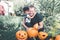 Halloween. Daughter hugging father. Man cuts a lid from pumpkin as he prepares jack-o-lantern. Decoration for party. Toned photo