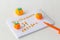 Halloween decoration from plasticine: pumpkins and spiders on a white wooden background with a inscription