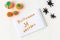 Halloween decoration from plasticine: pumpkins and spiders on a white wooden background with a inscription