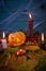 Halloween decoration with scarecrow pumpkins and candles