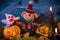 Halloween decoration with scarecrow pumpkins and candles
