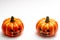 Halloween decorations concept, Two scary smiling pumpkins on white background