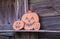 Halloween decorations on old wooden wall background. Paper pumpkins. Pumpkin family