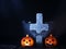 Halloween decorations with pumpkins and cauldron on dark background