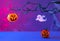 Halloween decorations with pumpkins, spider, spider web, ghost and bat on neon background. Halloween party concept