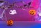 Halloween decorations with pumpkins, spider, spider web, ghost and bat on neon background. Halloween party concept