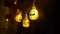 Halloween or Dia de los Muertos party decoration, lighting. Swinging string of pumpkin lights, leaves. Closeup HD footage.