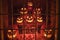 Halloween display of glowing jack-o-lanterns in a store window at night, Connecticut.