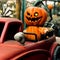 A Halloween doll (pumpkin) driving a car