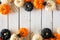 Halloween double border of orange, black and white pumpkins, bones and spiders over white wood
