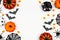 Halloween double side border flat lay of pumpkins, candy and decor, over a white background