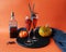 Halloween drinks, wine, pumpkin, burning candle on orange background