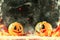 Halloween festive composition with smiling pumpkins guards, fire and smoke on dark background, selective focus