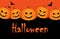 Halloween. Festive modern poster with pumpkins that smile scary in orange and black colors.