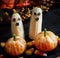 Halloween food Banana ghosts and Clementine Pumpkins on dark spooky background