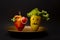 Halloween food with colorful healthy stuffed red and yellow sweet bell peppers with cutout faces in the skin like