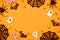 Halloween frame of scattered candy and decor over an orange background