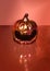 Halloween futuristic pumpkin scary minimal arrangement. Creepy minimal terracotta sparkling background