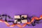 Halloween gift box with ribbon and paper decoration on traditional purple background. Holiday, Birthday, Halloween party