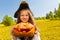 Halloween girl in costume of pirate holds pumpkin