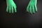 Halloween green witches or zombie monster hands on black background