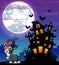 Halloween grey kitten wearing witches hat with scary castle in front of full moon