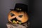 Halloween hat on pumpkin. jack o lantern with scary face in halloween hat. autumn holiday celebration. Ghosts were