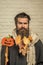 Halloween hipster with yellow leaves in beard hair