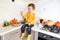 Halloween holiday , child on the kitchen with autumn leaf and decorations on the table