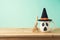 Halloween holiday concept with coffee cup and witch hat decor on wooden table