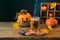 Halloween holiday concept with cup of tea and pumpkin decoration on wooden table