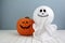 Halloween holiday concept with jack pumpkin and ghost decor on wooden table