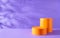 Halloween holiday concept. Orange Podiums or pedestals for products display on purple background