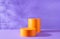 Halloween holiday concept. Orange Podiums or pedestals for products display on purple background