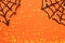 Halloween holiday concept. Spider webs over orange background. Top view, flat lay.