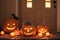 halloween holiday decoration with pumpkins, autumn leaves and candles, still life, cozy, festive background