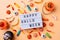 Halloween holiday decorations and sweets with lightbox with words Happy Halloween flat lay on orange background