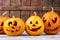 Halloween holiday pumpkins on wooden background.