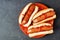 Halloween hot dog fingers on an orange plate over slate