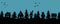 Halloween houses. Spooky village. Seamless border. Black silhouettes of houses and fir trees on a blue background