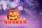 Halloween illustration with candle and pumpkin violet background