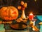 Halloween image of table with pumpkin, burning candle,