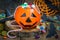 Halloween Jack o Lantern bucket overflowing with candy, spooky decorations on background horizontal