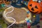 Halloween Jack o Lantern bucket overflowing with candy, spooky decorations, horizontal, copy space