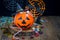 Halloween Jack o Lantern bucket overflowing with candy, spooky Halloween decorations on background, copy space