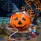 Halloween Jack o Lantern bucket overflowing with candy, spooky Halloween decorations on background, square